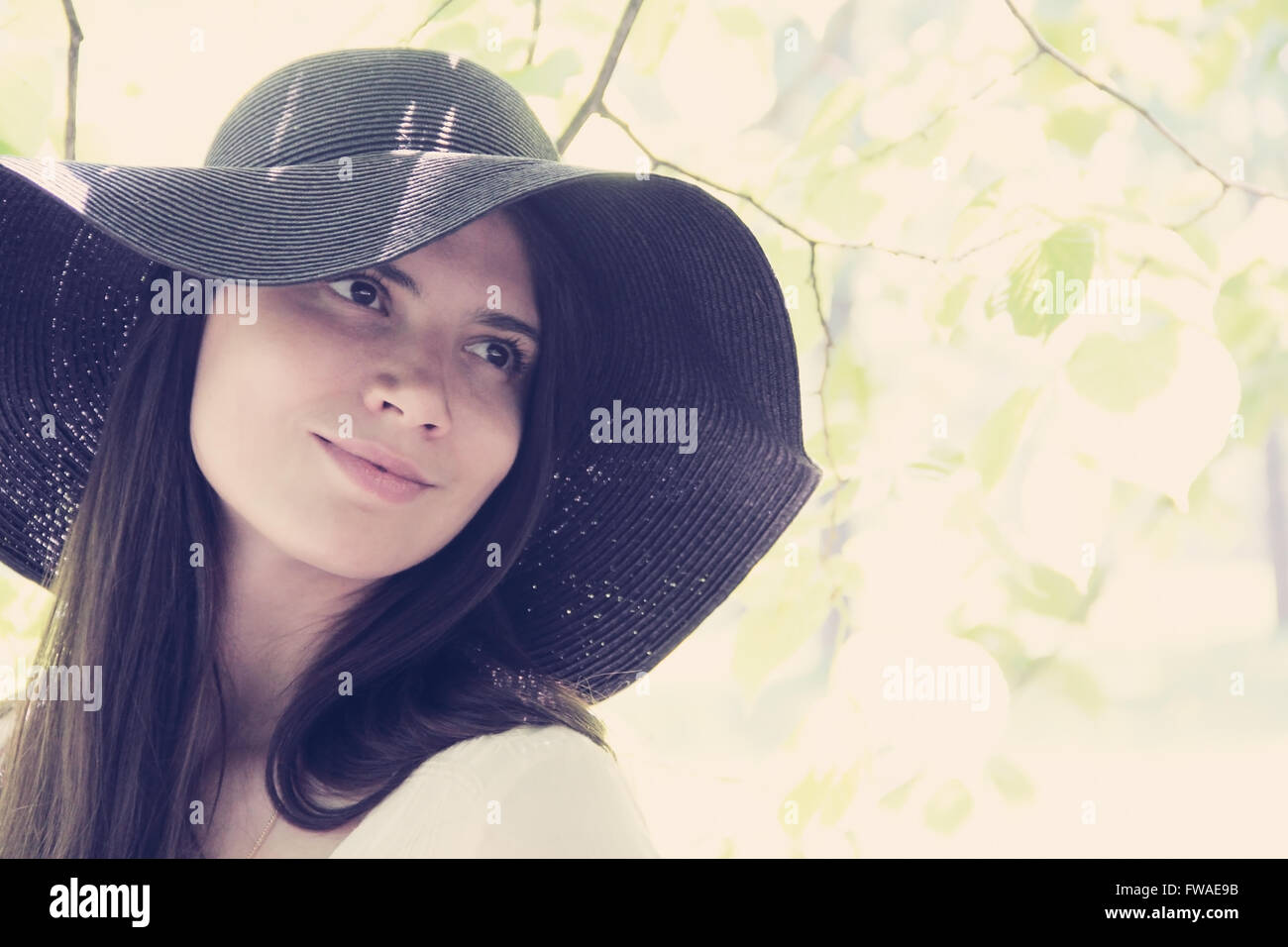 Portrait of a beautiful woman in hat in spring park Stock Photo - Alamy
