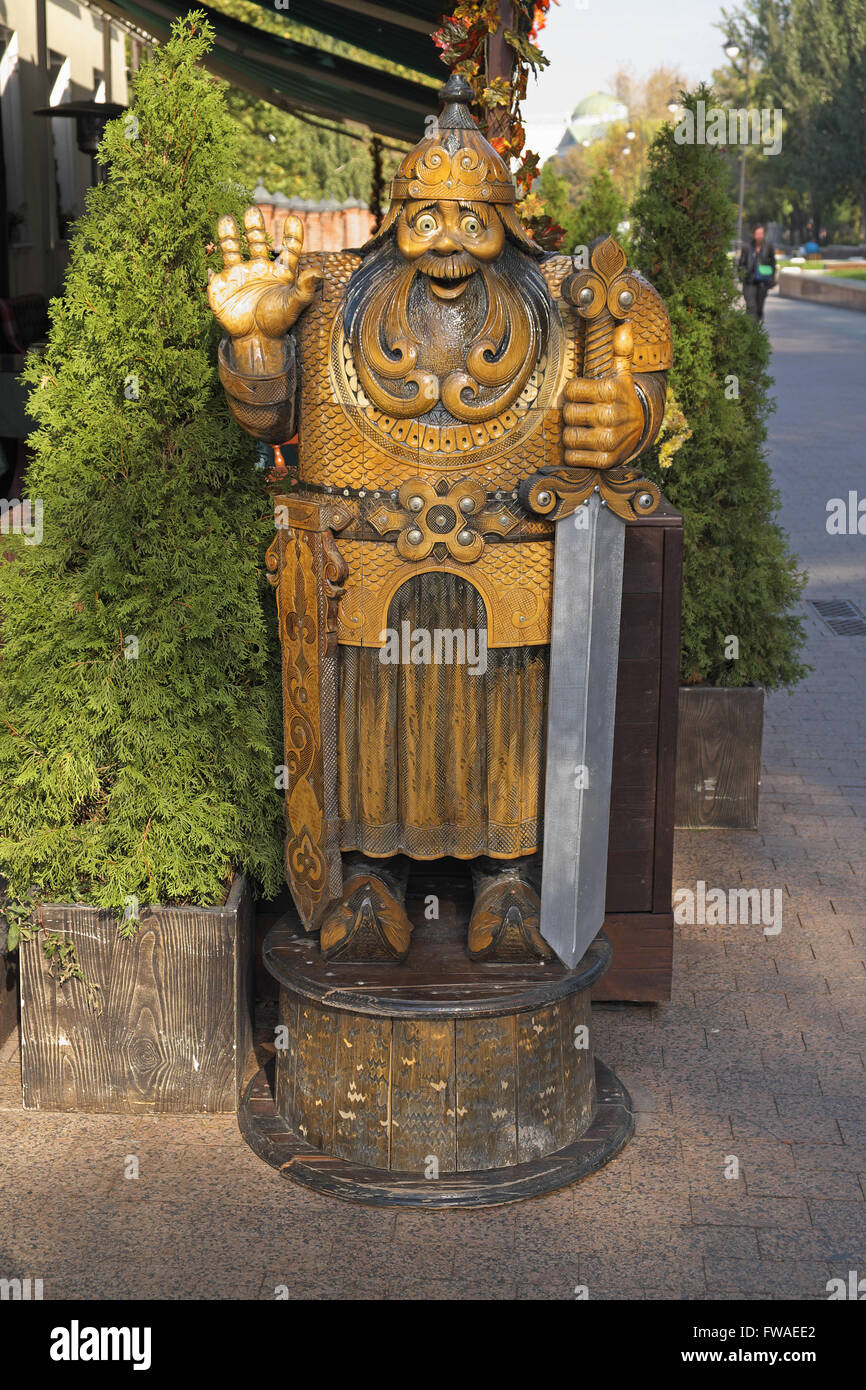 Carved wooden figure outside a restaurant on Lavrushinskly pereulok, near the Tretyakov Gallery, Moscow, Russia. Russian warrior Stock Photo