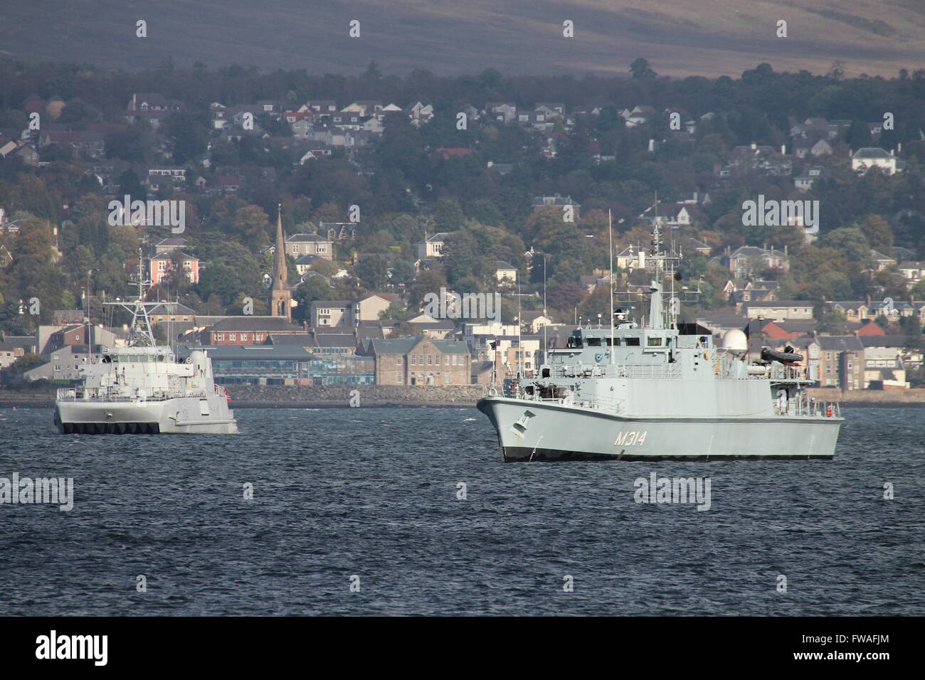 KNM Karmoy (left) and ENS Sakala (right), sit at anchor off Greenock Esplanade shortly after arriving for Joint Warrior 14-2. Stock Photo