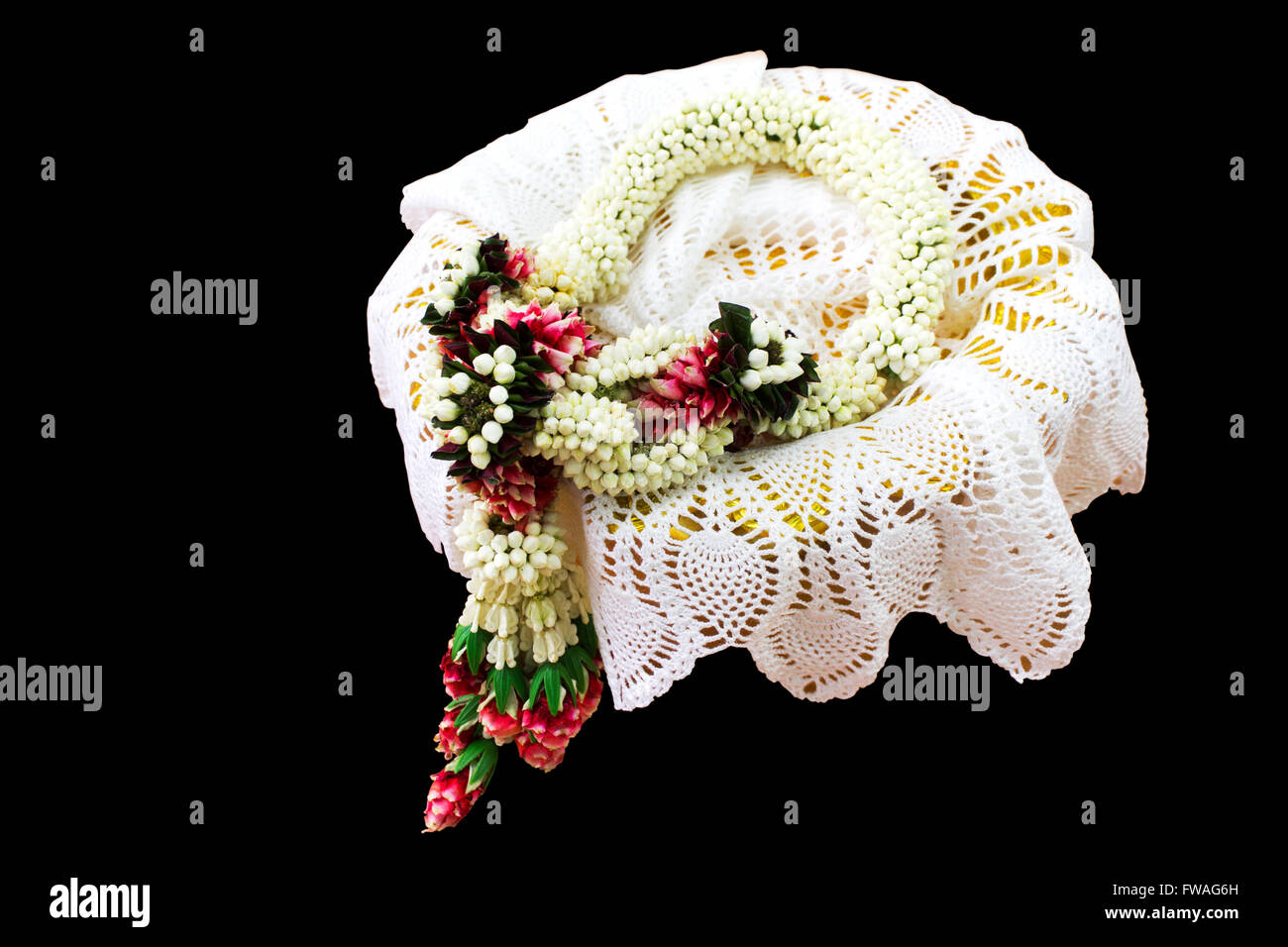 Jasmine garland at lace cloth enter phan on isolated back background with clipping path Stock Photo