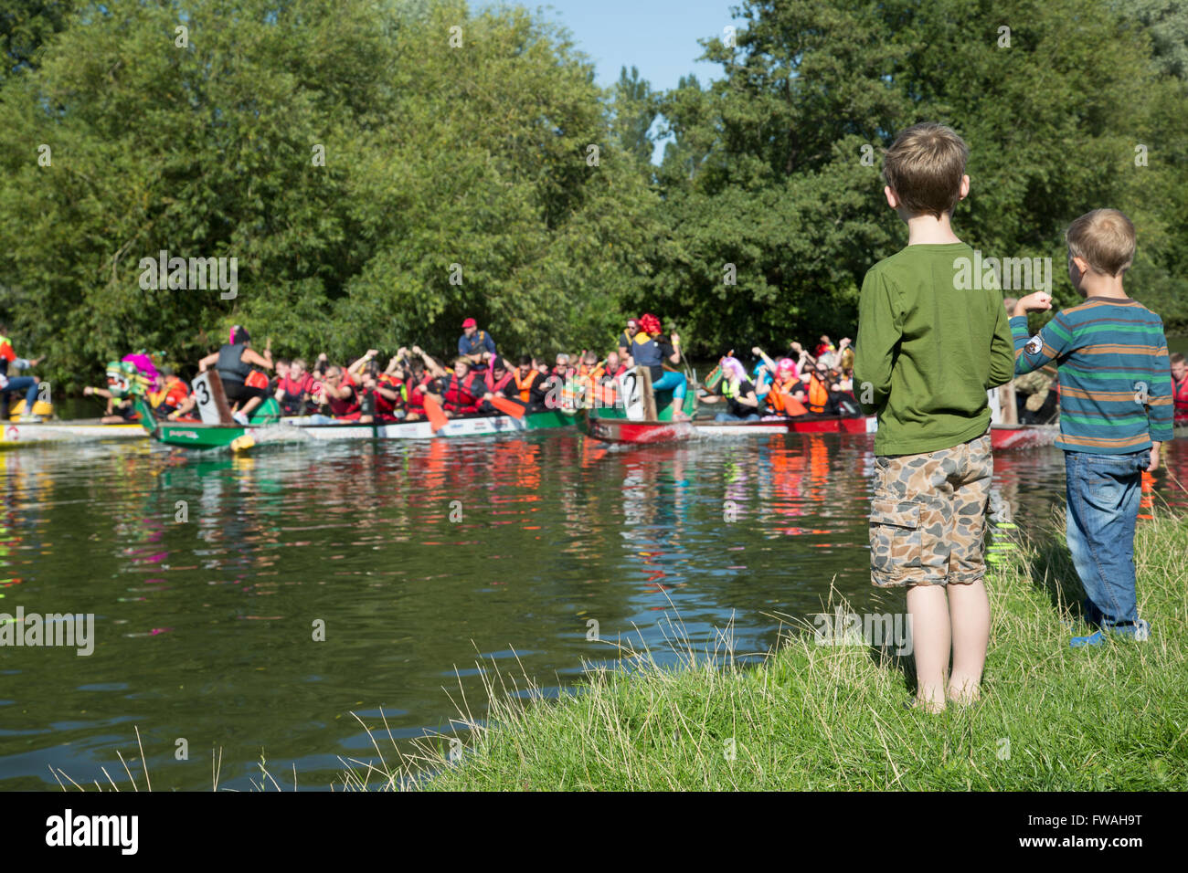 Two young boys cheer on the dragon boats Stock Photo