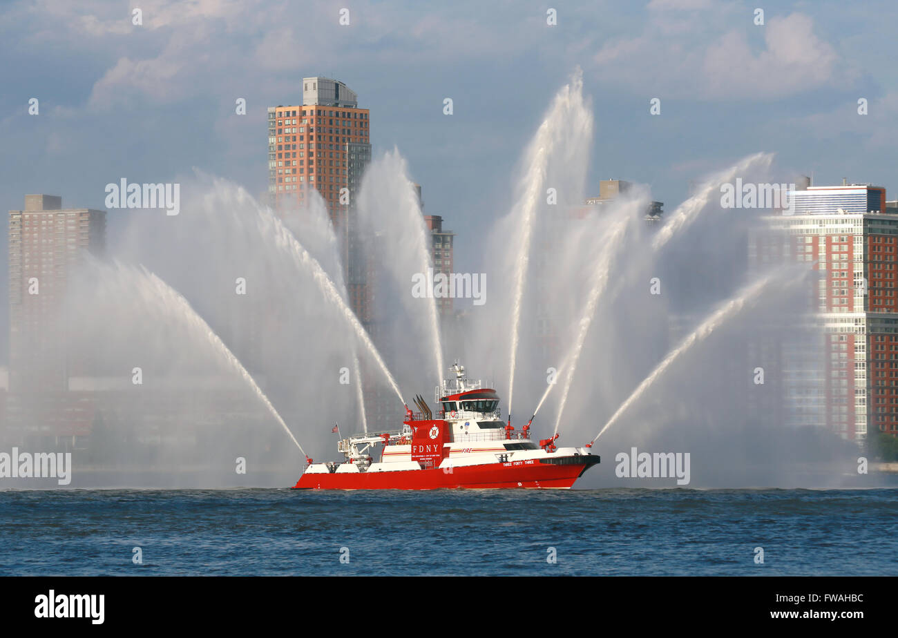 FDNY boat on the Hudson River, New York City sprays it's hoses near Ground Zero as a tribute to the victims of the 9/11 attacks. Stock Photo