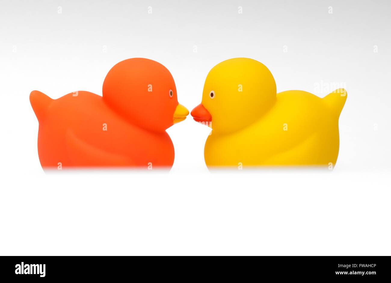 Orange and yellow toy ducks face to face Stock Photo Alamy