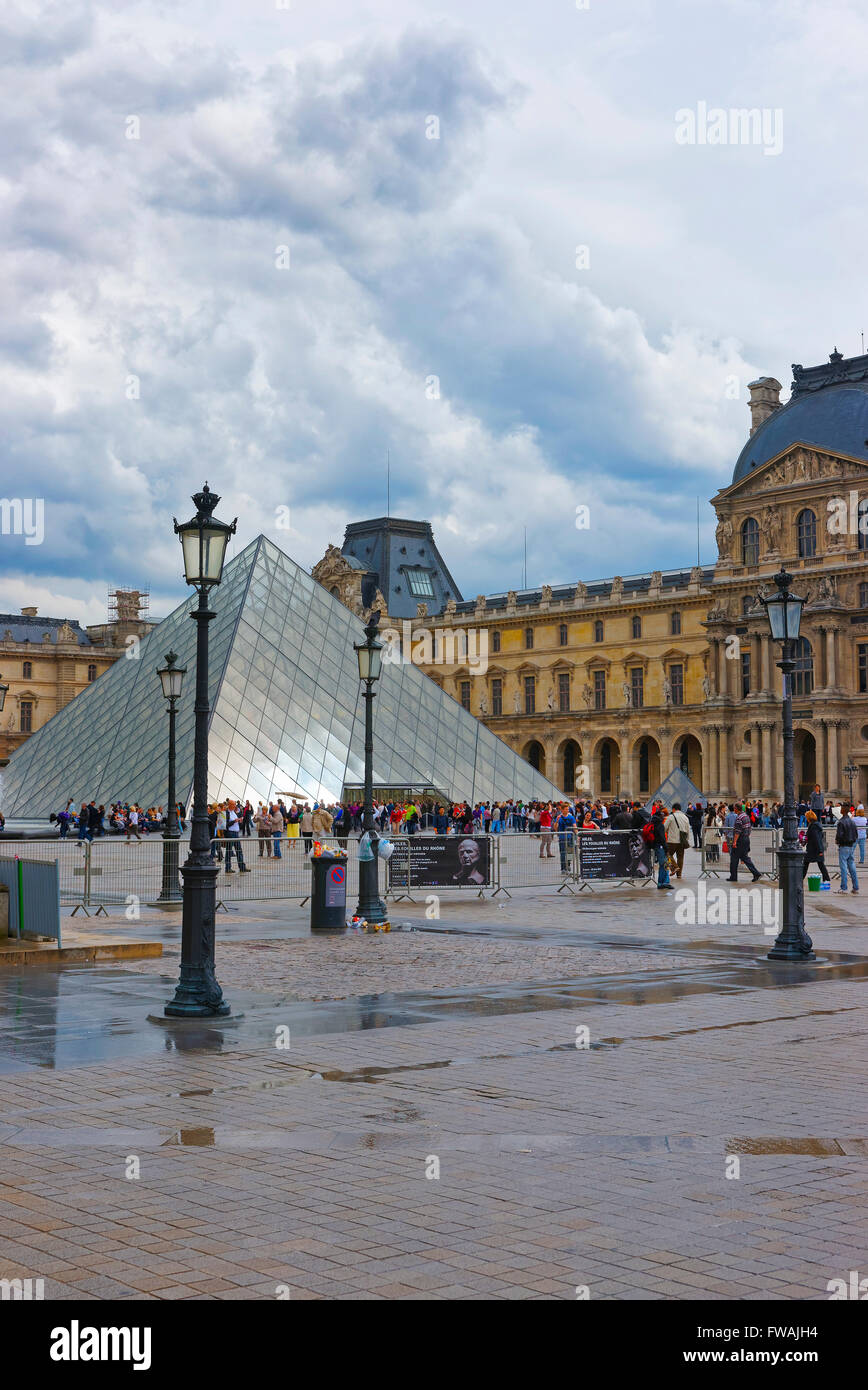 PARIS, FRANCE - MAY 4, 2012: Louvre Pyramid near Louvre Palace in Paris in France. Palace of Louvre now is a museum. Louvre Pyramid is a large metal and glass pyramid Stock Photo