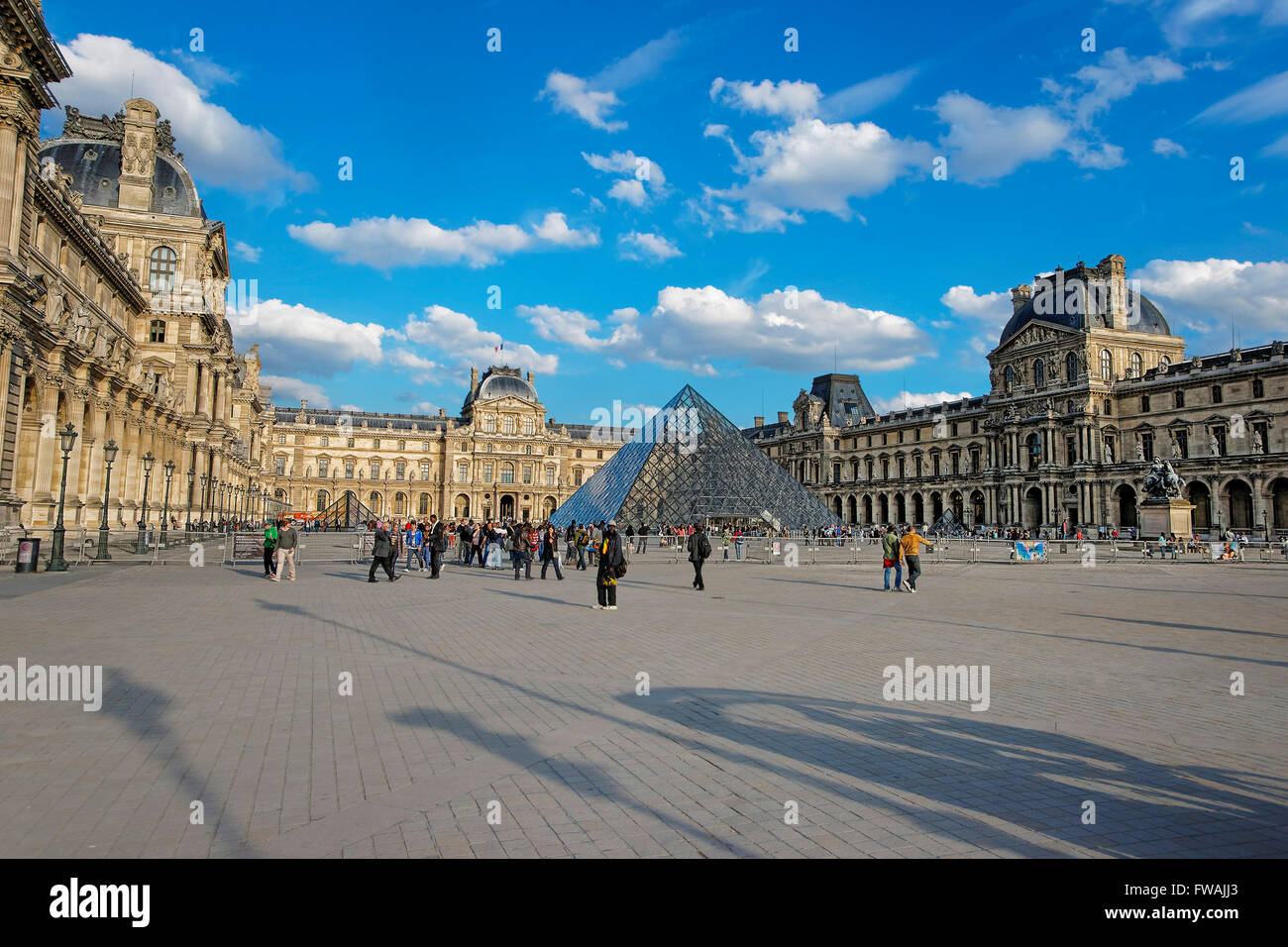 PARIS, FRANCE - MAY 3, 2012: Louvre Pyramid and Louvre Palace in Paris in France.  Palace of Louvre is a former royal palace and now is a museum. Louvre Pyramid is a large metal and glass pyramid Stock Photo