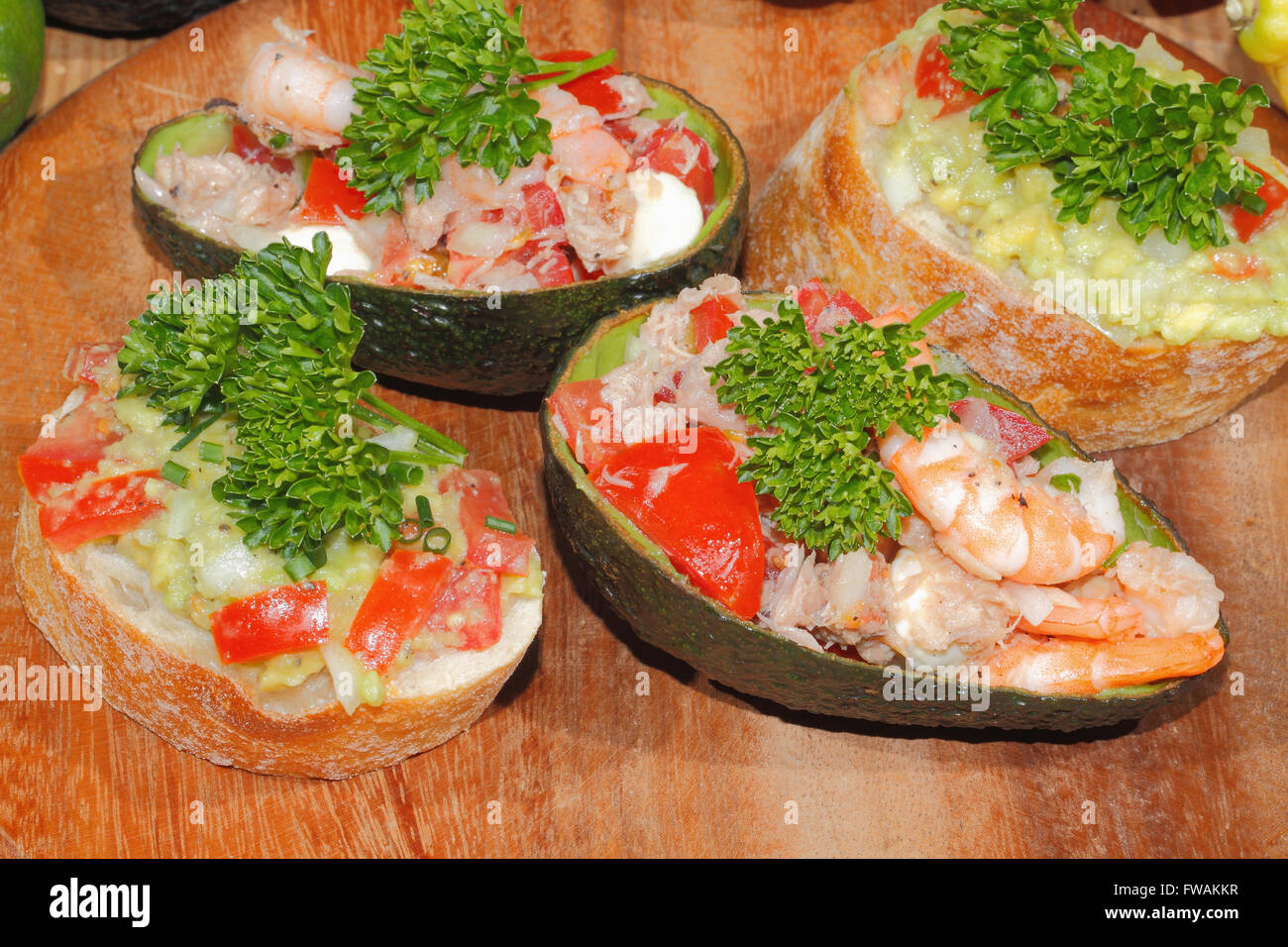 Plate of tomato salad, tuna and shrimp stuffed avocados and Ciabattas