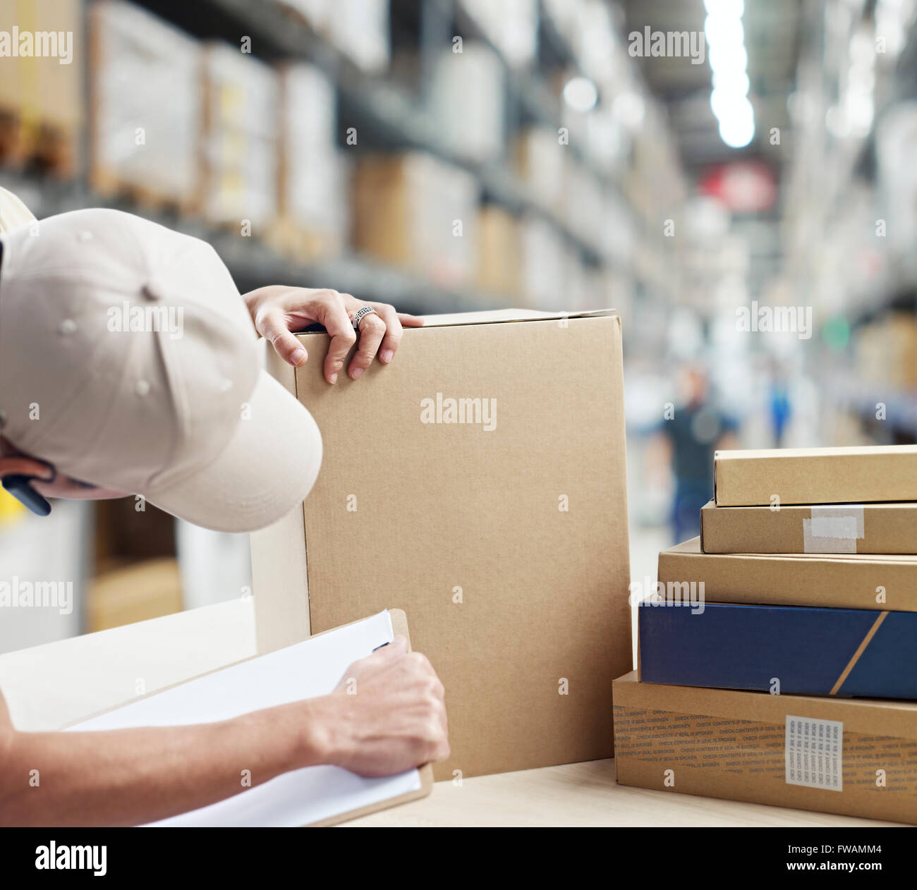 warehouse worker checking and recording goods Stock Photo