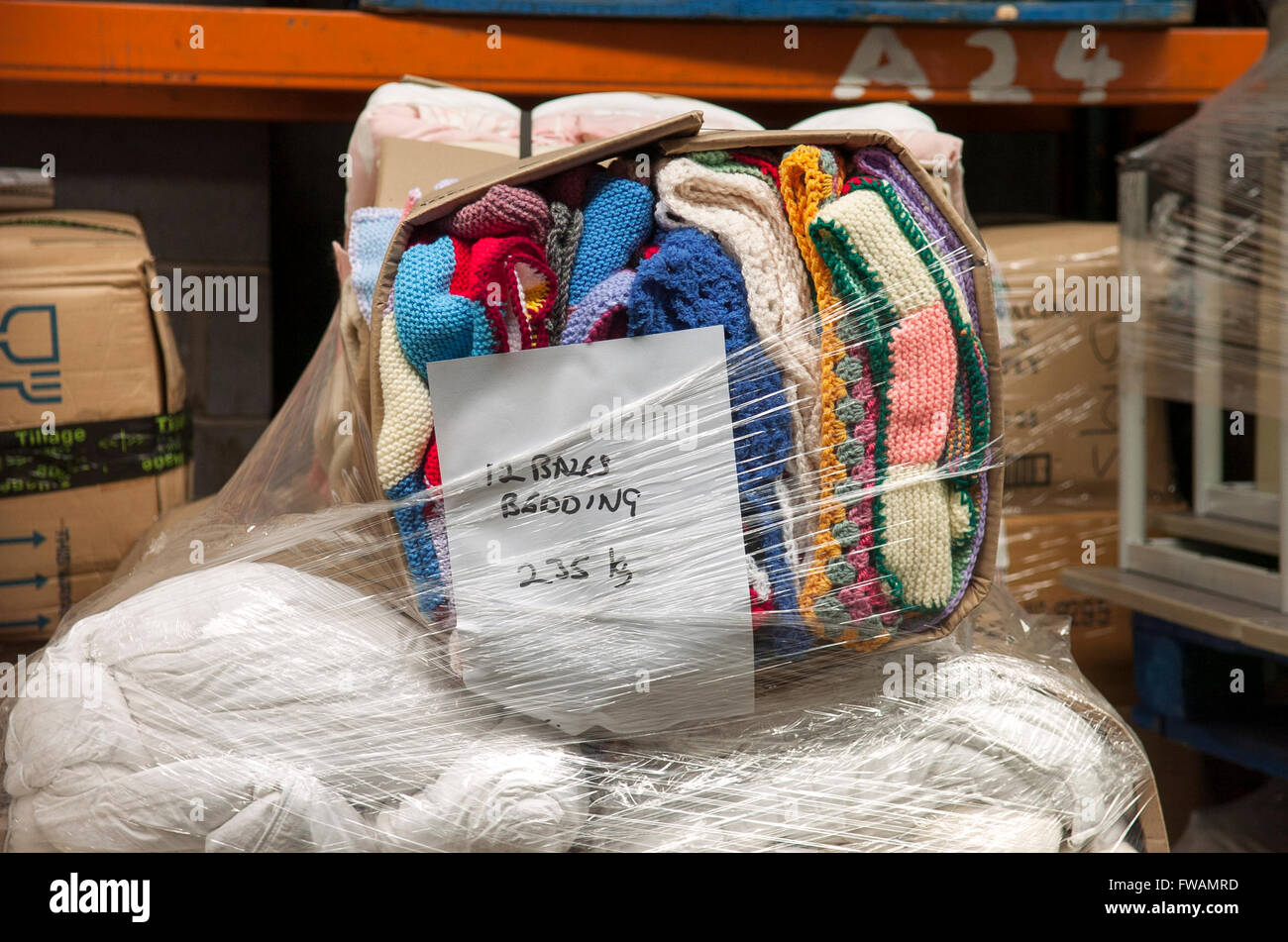 Much Hoole, Preston, Lancashire. A bale of hand knitted colourful blankets wait at the International Aid Trust warehouse, ready to be donated to those that need them. The charity raise funds and aid for humanitarian causes across the globe. Stock Photo