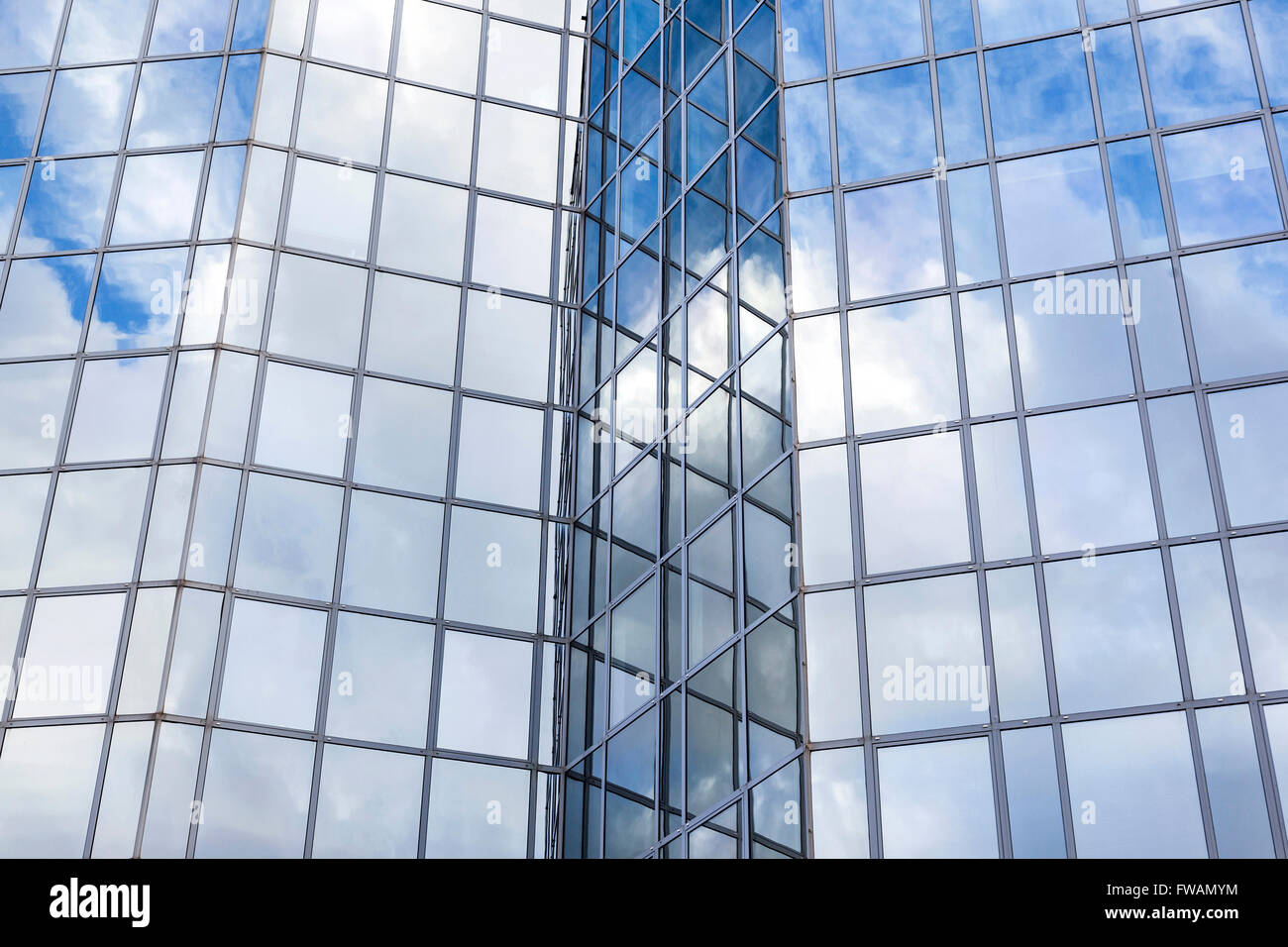 glass office facade reflects clouds and blue sky Stock Photo - Alamy