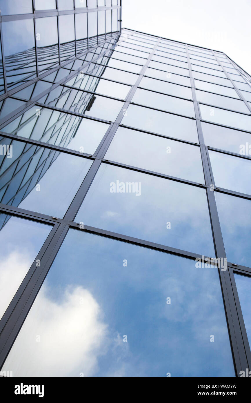 glass office facade reflects clouds and blue sky Stock Photo - Alamy