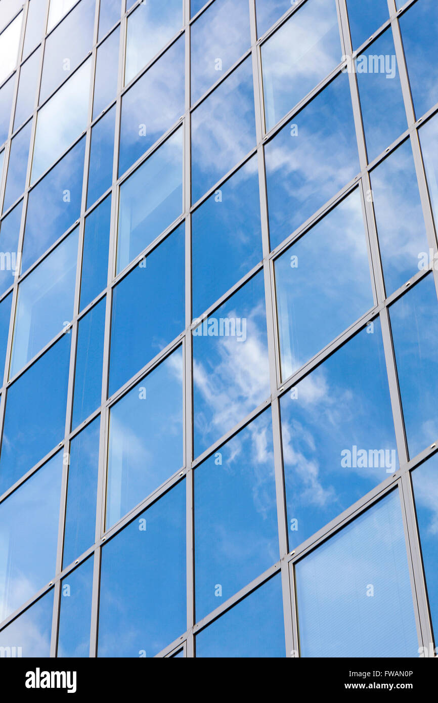 glass office facade reflects clouds and blue sky Stock Photo - Alamy