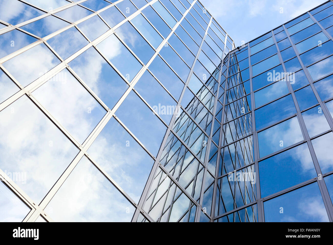 glass office facade reflects clouds and blue sky Stock Photo - Alamy