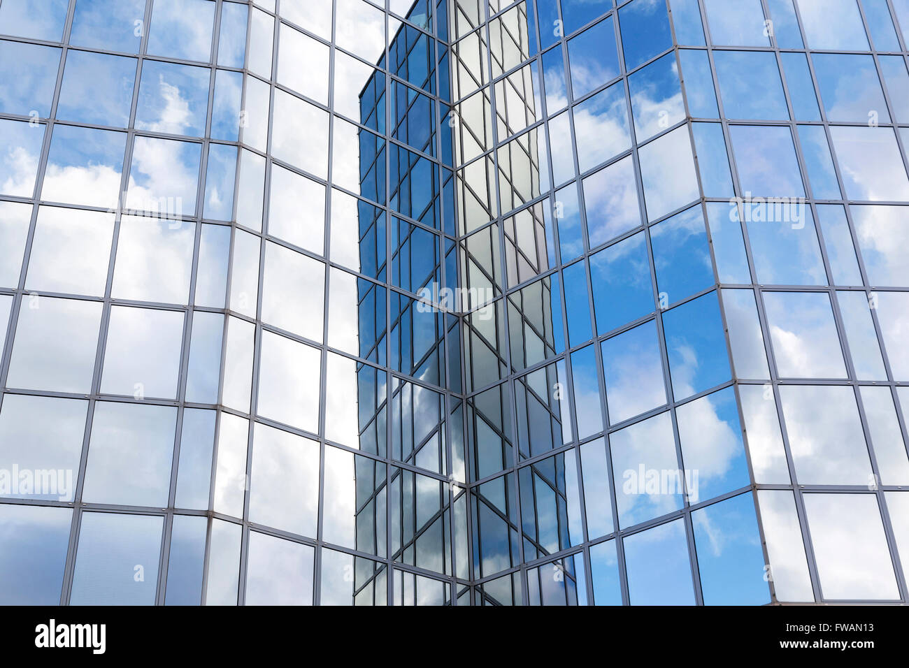 glass office facade reflects clouds and blue sky Stock Photo - Alamy