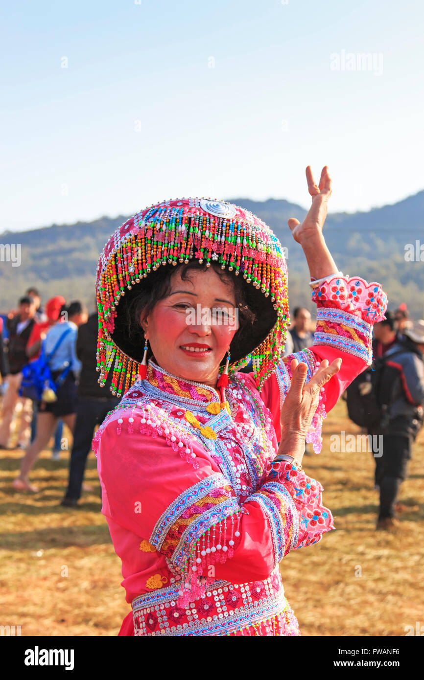 Heqing, China - March 15, 2016: Chinese woman in traditional Miao attire during the Heqing Qifeng Pear Flower festival Stock Photo