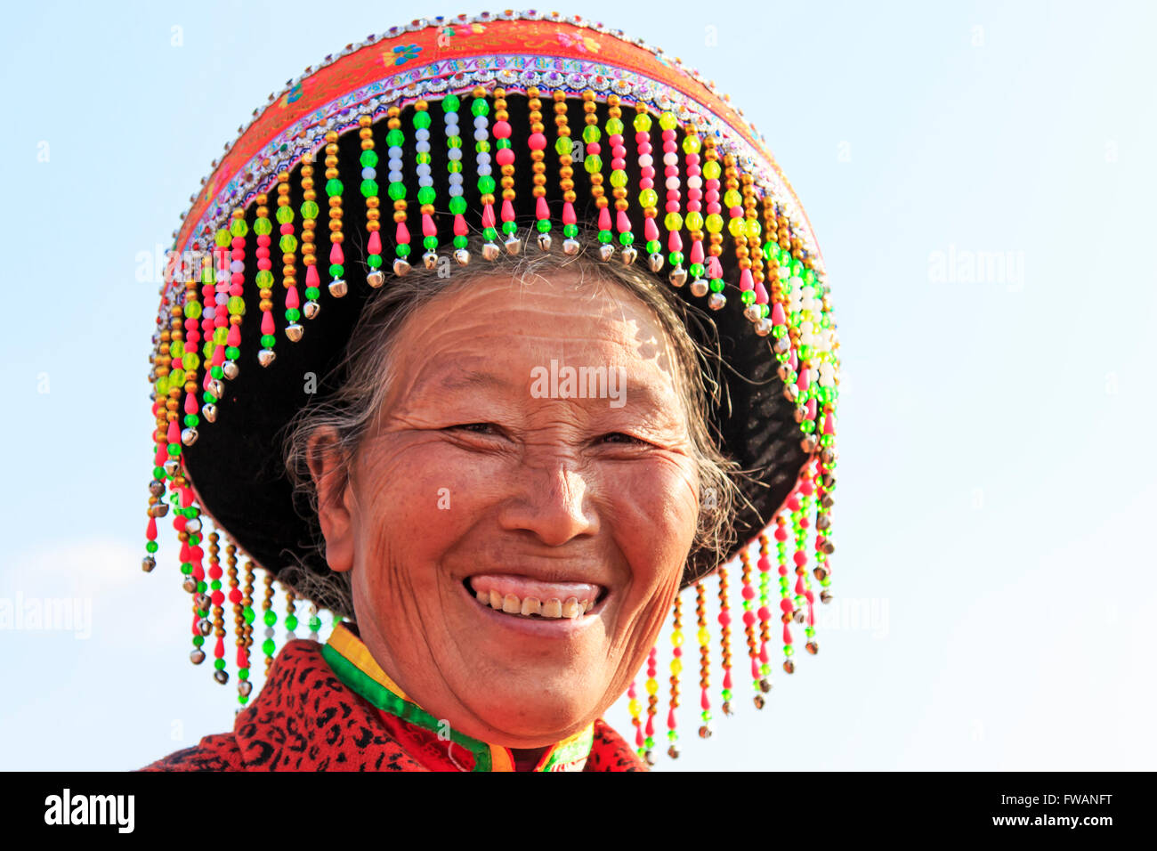 Heqing, China - March 15, 2016: Chinese woman in traditional Miao attire during the Heqing Qifeng Pear Flower festival Stock Photo