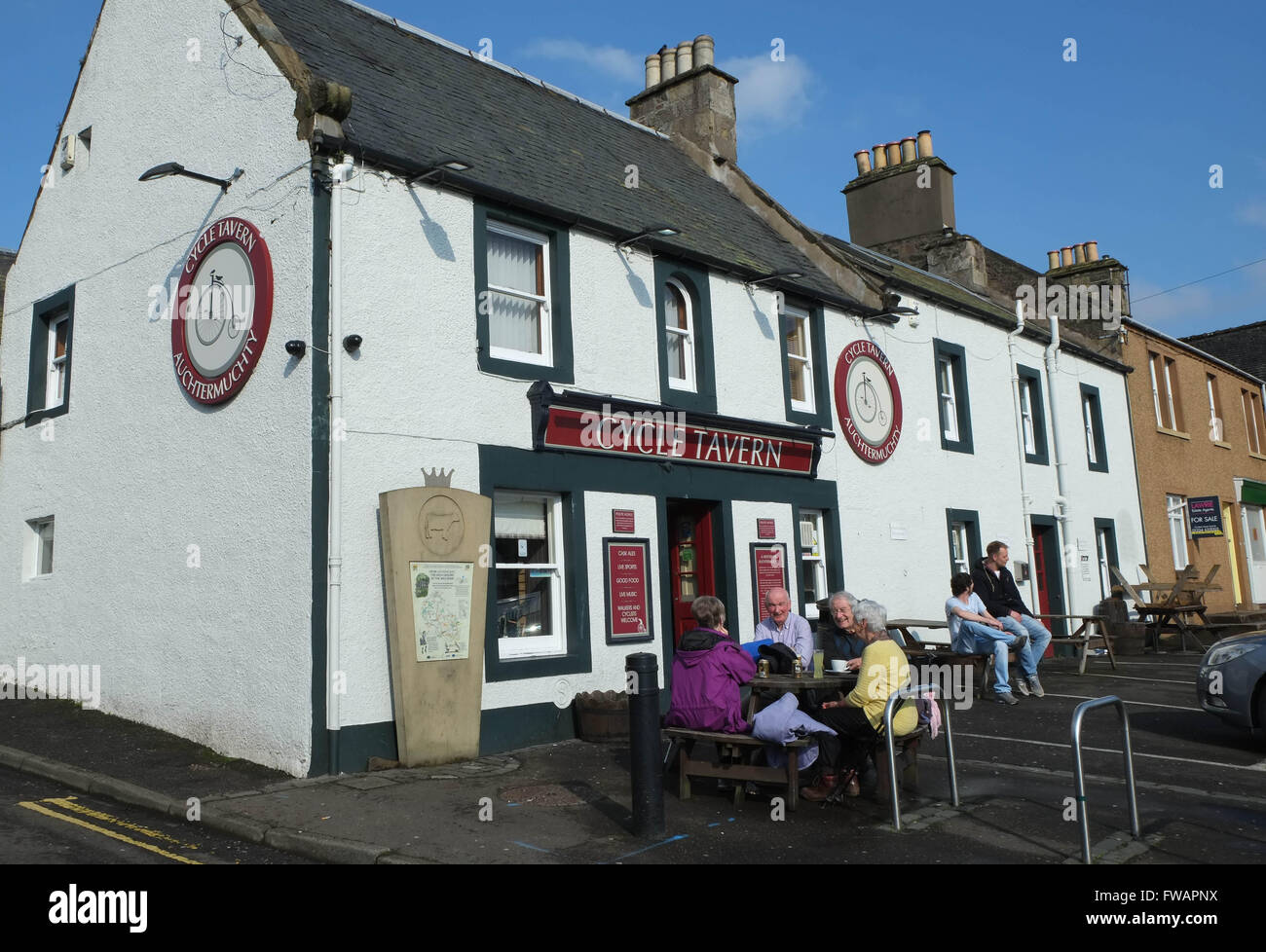 Customers enjoy a refreshment outside the Cycle Tavern in Auchtermuchty, Fife, Scotland, Stock Photo