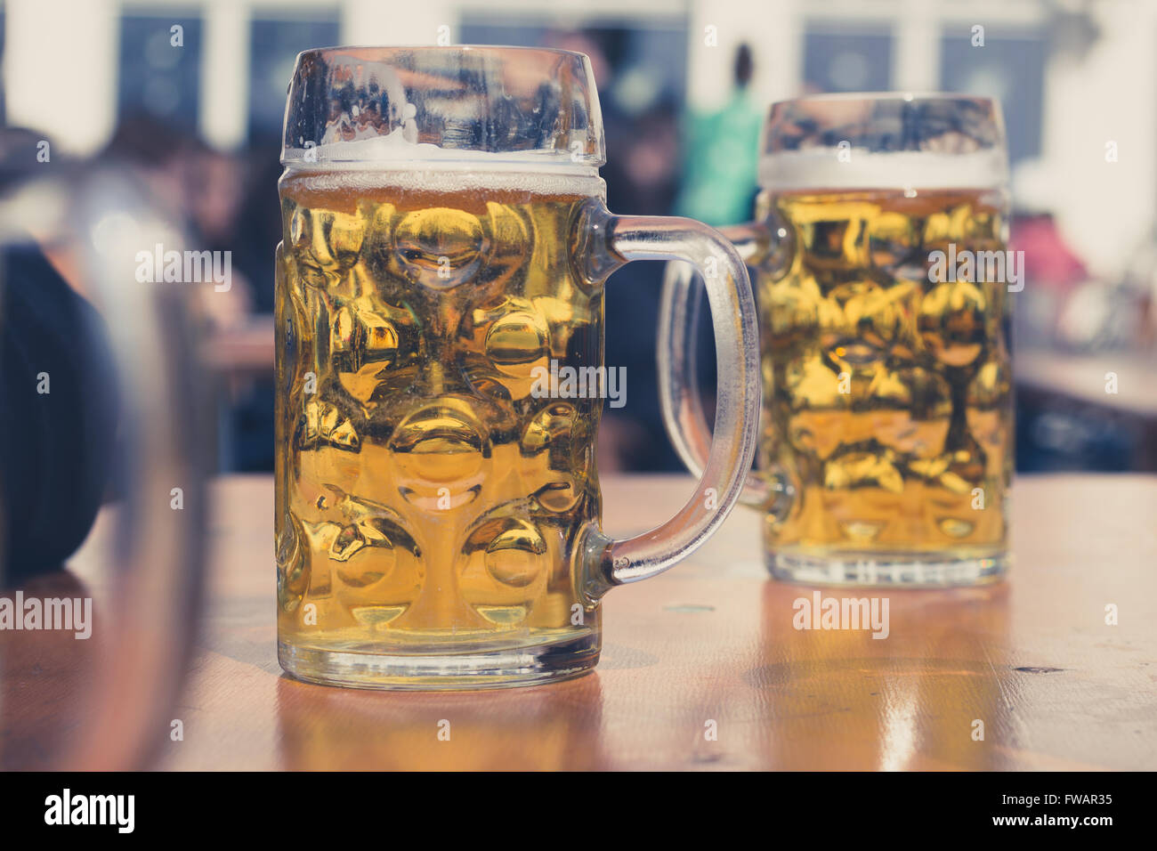 two beer glasses in german beer garden background Stock Photo