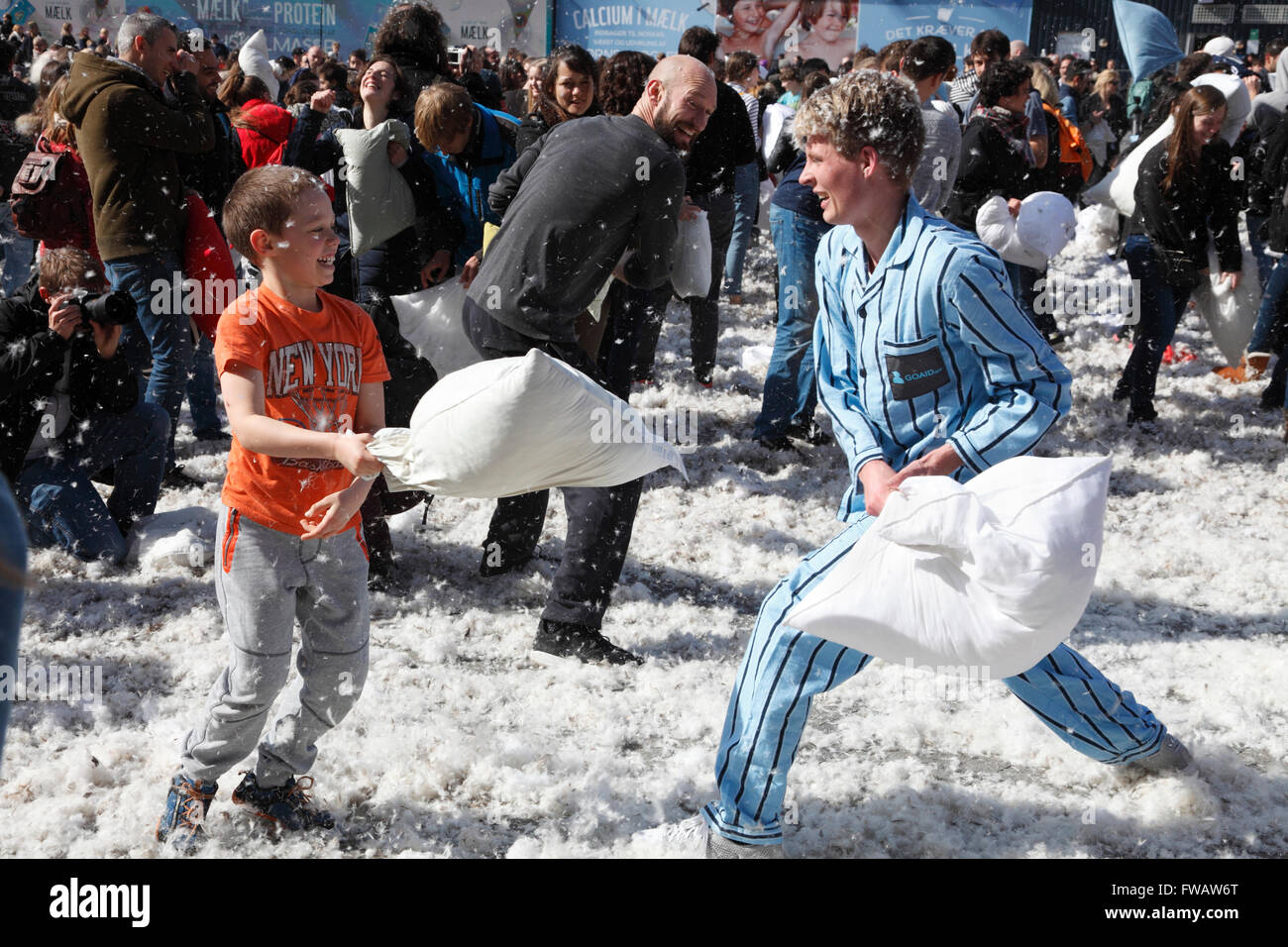 Copenhagen, Denmark, 2nd April, 2016. Massive pillow fights in the City Hall Square in Copenhagen on the 7th International Pillow Fight Day attract many hundreds of participants and spectators of all ages on this sunny Saturday afternoon. More than 100 cities around the world take part in this spectacular and funny annual event. Behind the idea is the Urban Playground Movement, a playful part of the larger public space movement. Credit:  Niels Quist/Alamy Live News Stock Photo