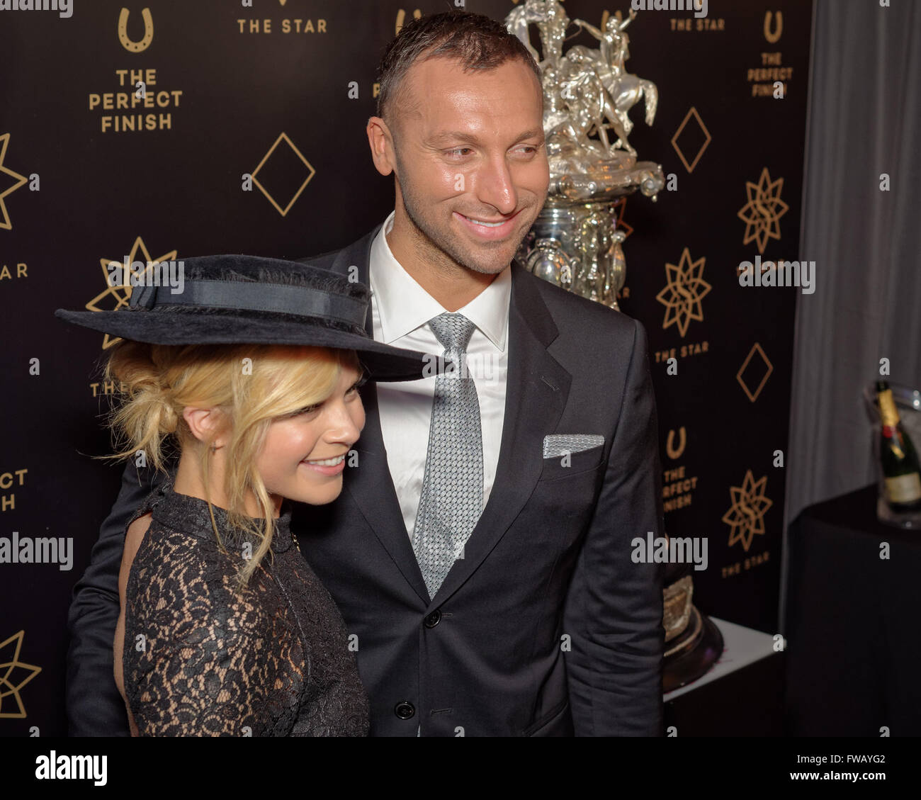 Sydney, Australia. 02nd Apr, 2016. Gold medal Olympic swimmer Ian Thorpe and Emma Freedman poses next to the Championships racing trophy during a photo call during The Championships Day at Royal Randwick features the world's richest horse races in Sydney, Australia. Ian Thorpe revealed he was gay in an interview with Sir Michael Parkinson in 2014. © Hugh Peterswald/Pacific Press/Alamy Live News Stock Photo