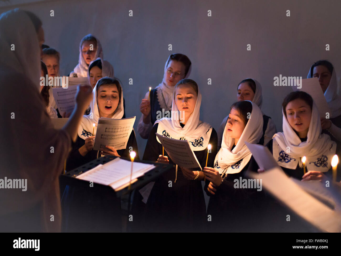 A Russian Orthodox women sing hymns during Veneration of the Cross Great Vespers service at the Theological Academy April 2, 2016 in Saint Petersburg, Russia. The veneration is held on the Third Sunday of Great Lent in accordance with Orthodox beliefs. Stock Photo