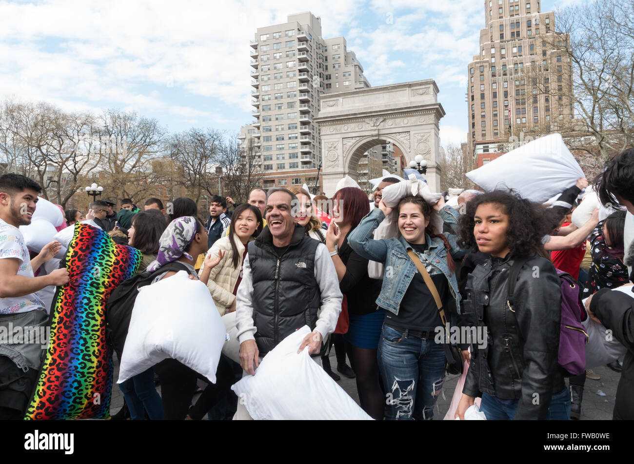Crowd of people laughing and smiling holding pillows in the worlds