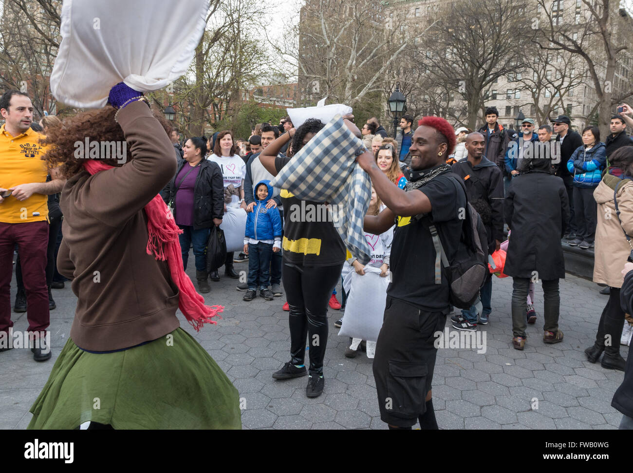 Young man and woman having a pillow fight in the worlds largest pillow