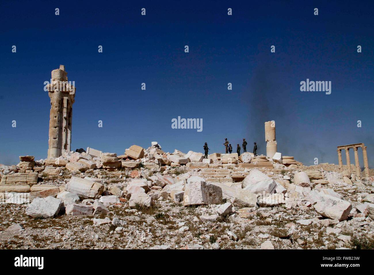 Beijing, China. 1st Apr, 2016. Several Syrian soldiers are seen on a damaged ancient temple in Palmyra of central Syria, on April 1, 2016. Syria's ancient city of Palmyra has been retaken by Syrian government forces from the Islamic State fighters. However, the city full of antiquities and ancient architectures has suffered destruction during the IS control. © Yang Zhen/Xinhua/Alamy Live News Stock Photo