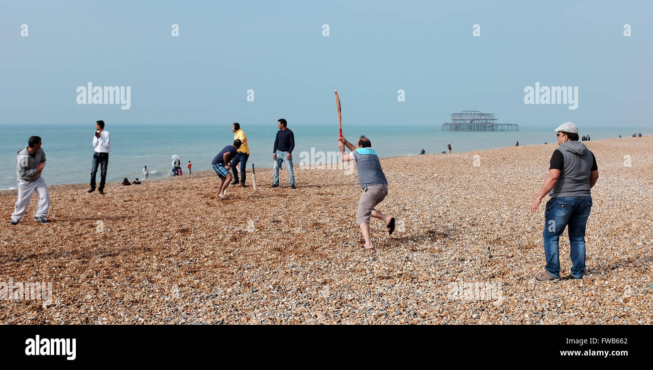 Brighton, UK. 3rd April, 2016. On the same day as the T20 Cricket World Cup Final is held  in India a group enjoy an impromptu game on Brighton beach this morning in the warm sunny weather with temperatures in some parts of Britain forecast to reach the high teens centigrade later on  Credit:  Simon Dack/Alamy Live News Stock Photo
