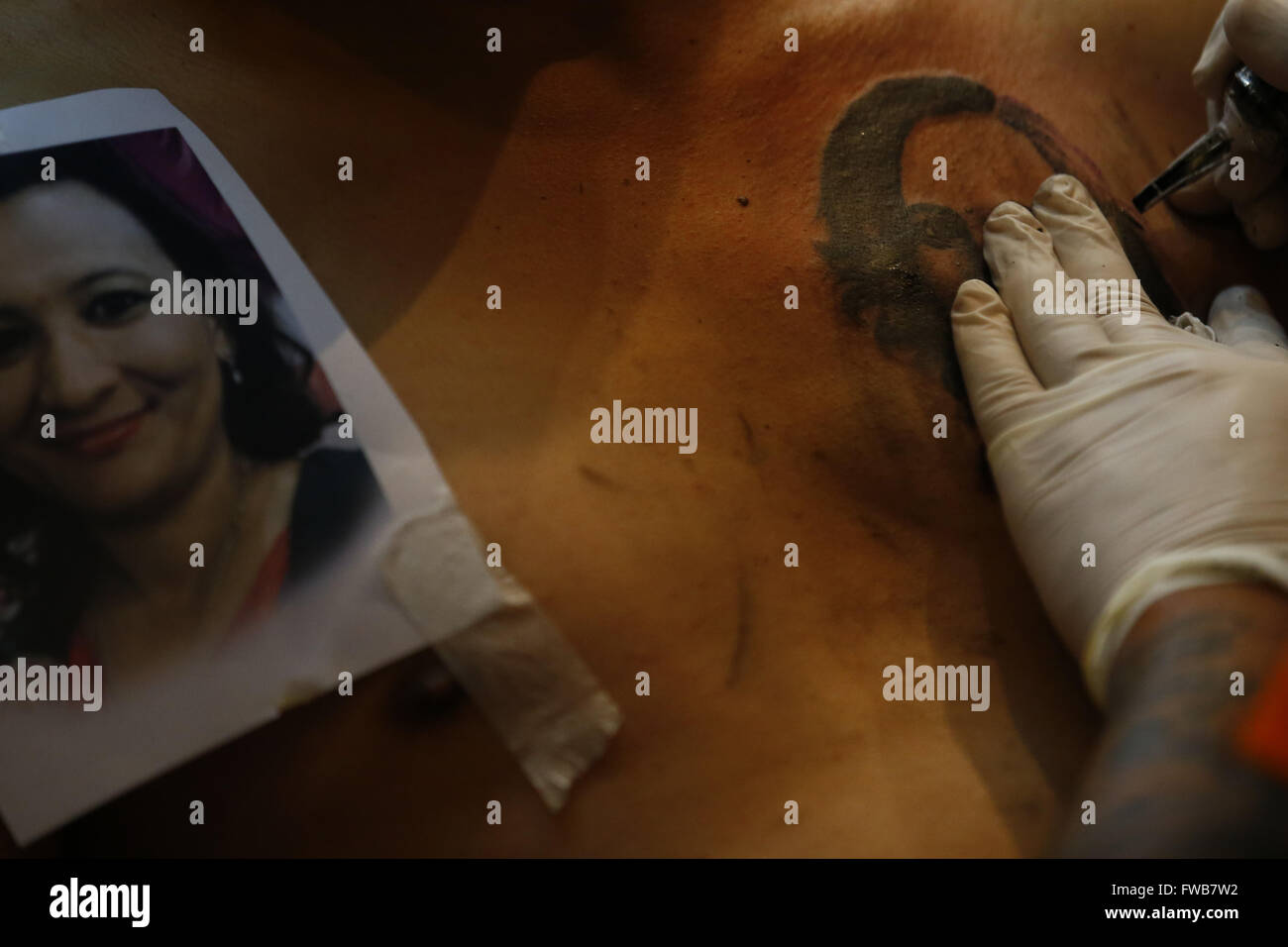 Kathmandu, Nepal. 3rd Apr, 2016. A tattoo artist works on a tattoo