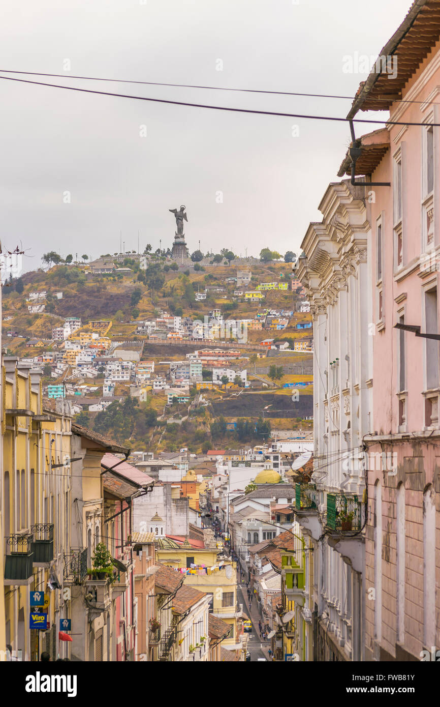 Low angle view of colonial classic style buildings and the famous panecillo hill at background in the historic center of Quito i Stock Photo
