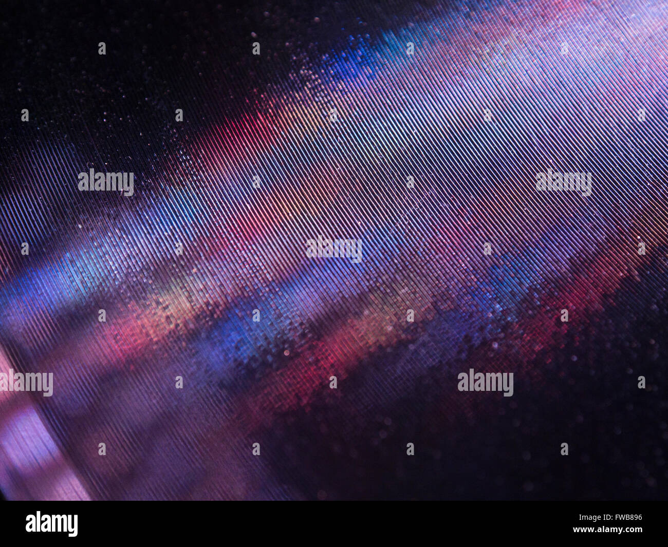 Multi coloured lights reflected in the grooves of an old shellac record Stock Photo