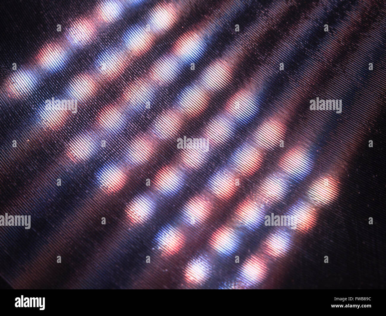 Multi coloured lights reflected in the grooves of an old shellac record Stock Photo