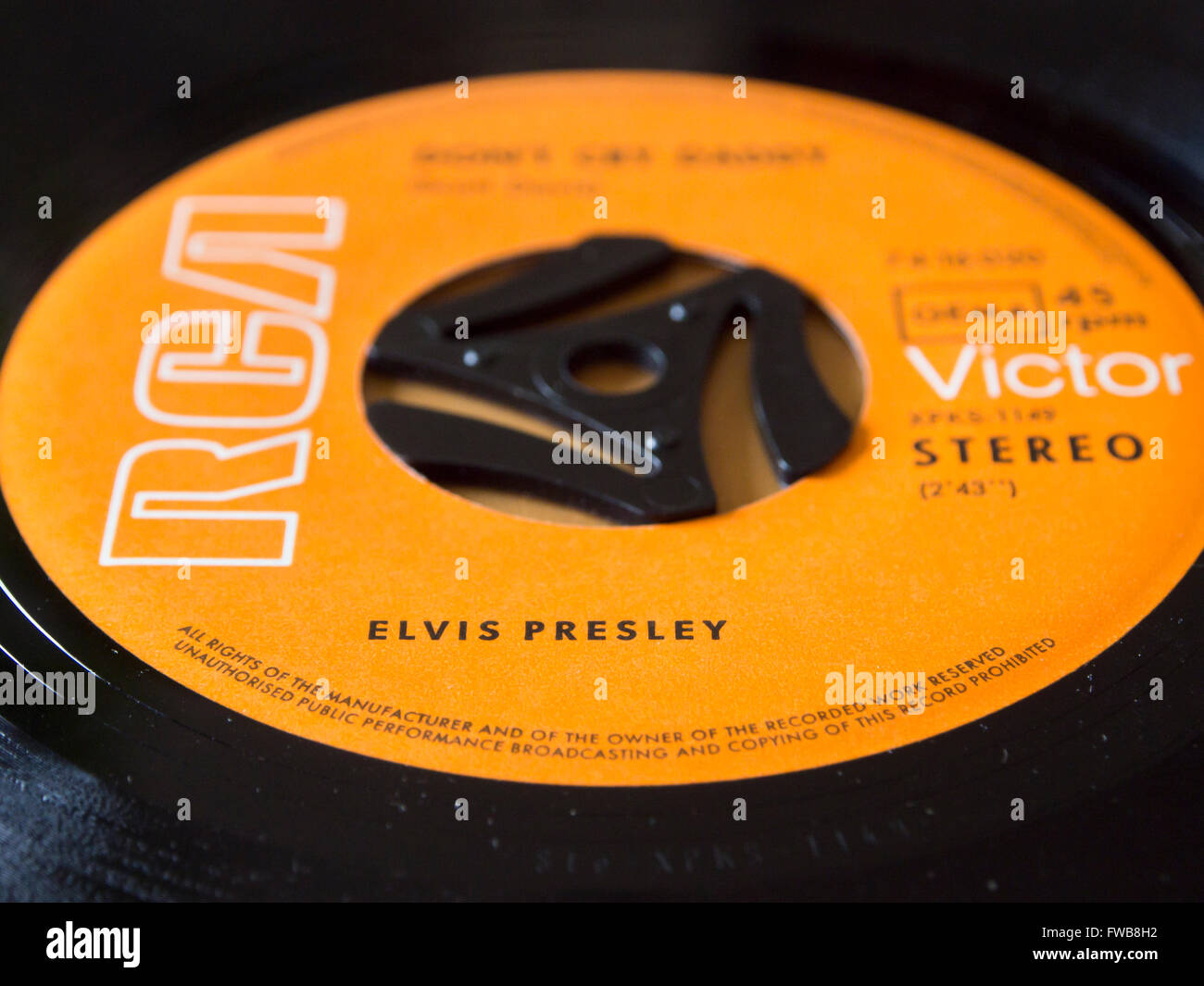 Vintage RCA Victor single record close up of orange label , singer Elvis Presley blurred title (Dont cry daddy) Stock Photo