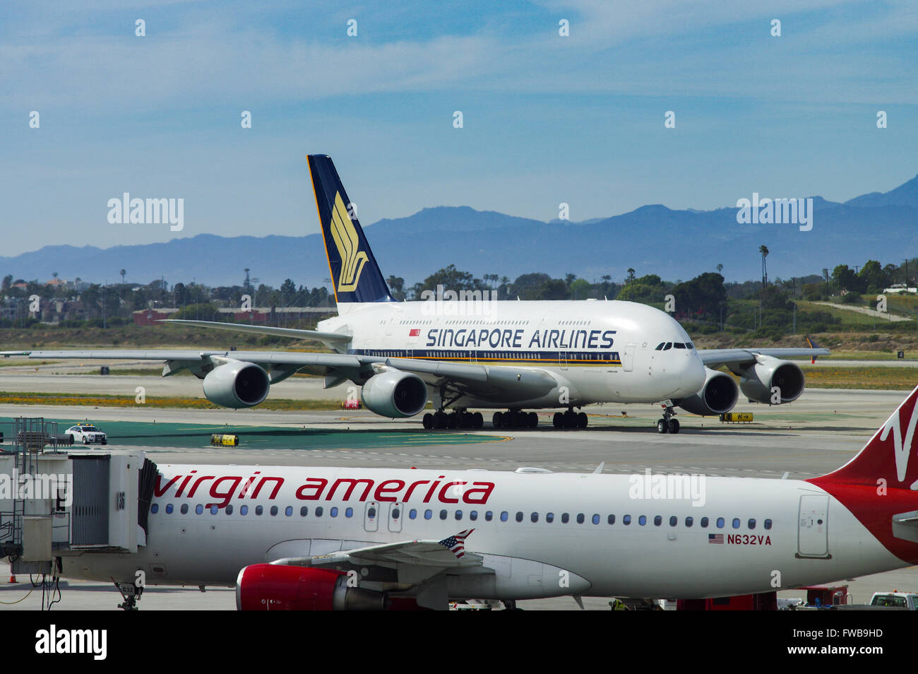 Virgin America A320 with Singapore Airlines A380 in the background on the tarmac in Los Angeles Airport Stock Photo