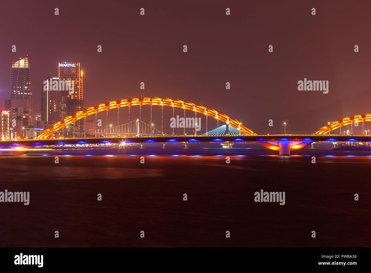 Illuminated Cầu Rồng or dragon bridge over the Han River at night, Da Nang, Central Vietnam, Vietnam Stock Photo