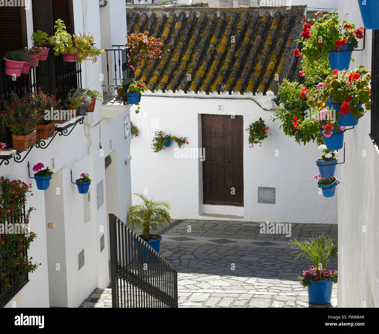 Estepona Old town quaint streets flower pots geraniums terra-cotta rooftops cobbled streets white village pueblo blanco Stock Photo