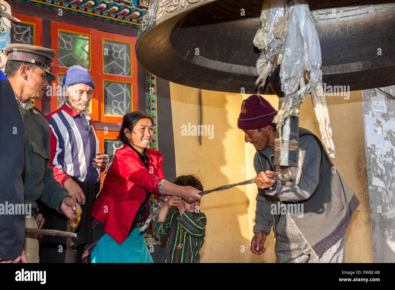 Bodhnath, Nepal.  Ringing Giant Bell to Celebrate Tibetan New Year. Stock Photo