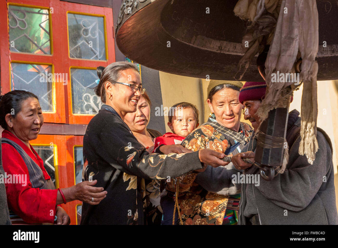 Bodhnath, Nepal.  Ringing Giant Bell to Celebrate Tibetan New Year. Stock Photo