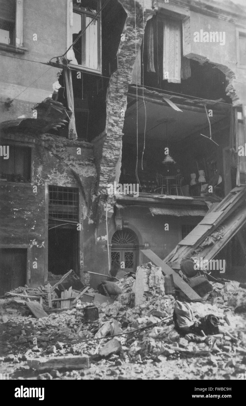 Furniture spills out from an artillery damaged home on the Italian front during WWI, possibly in Monastir (Bitola) Macedonia or Nervesa Italy. Stock Photo