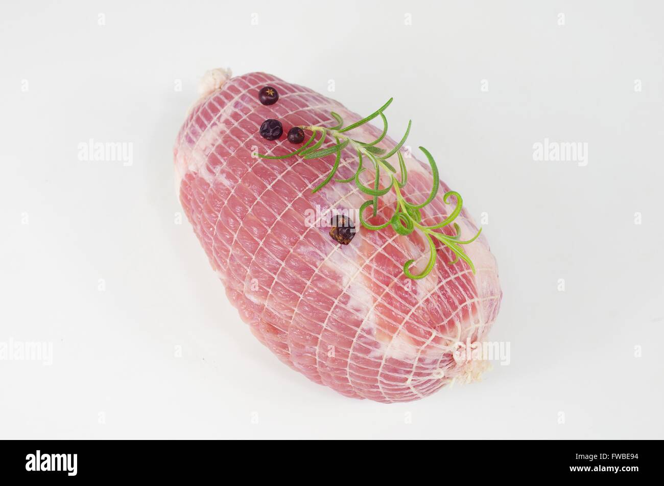 raw ham with rosemary and laurel on  plate Stock Photo