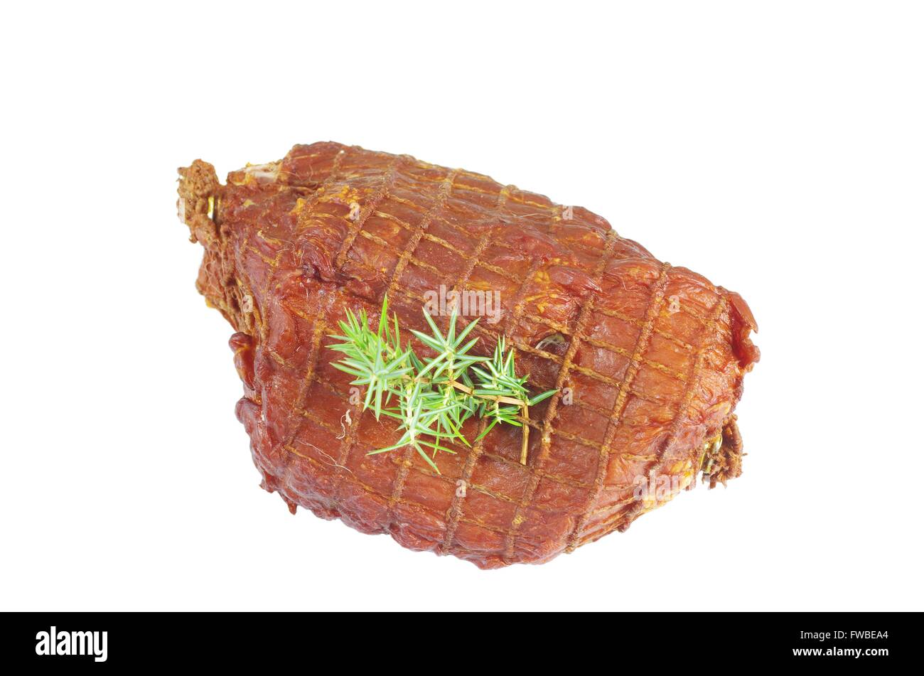 smoked ham with juniper on white background Stock Photo