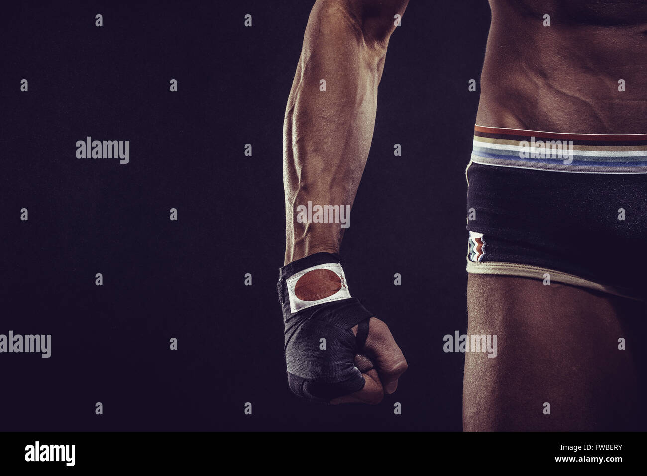 MMA Fighter Preparing Bandages For Training. Darck background Stock Photo