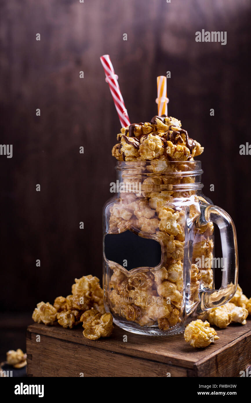 Sweet caramel popcorn in a glass jar Stock Photo