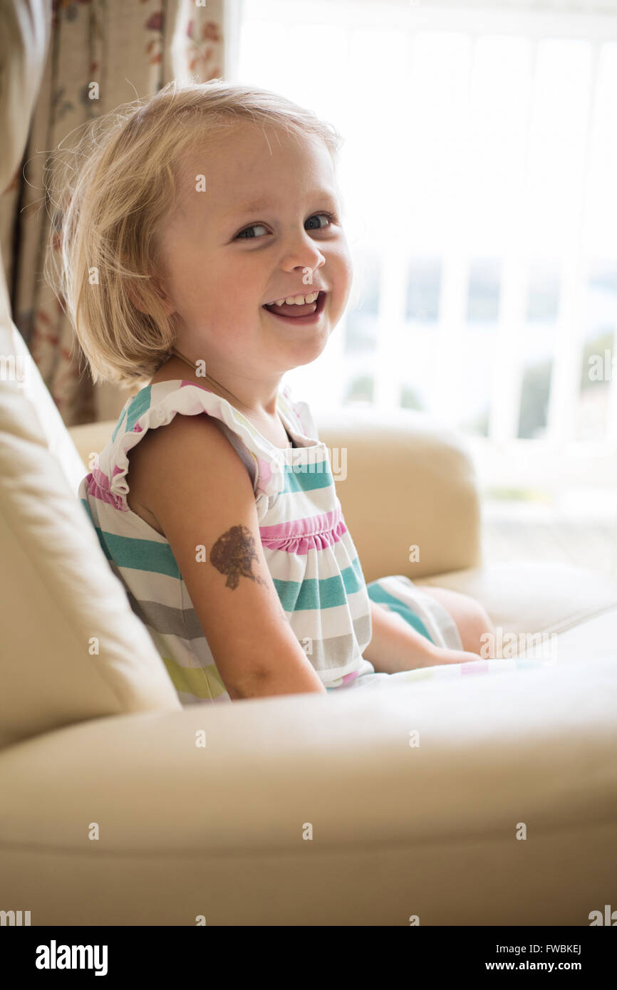 girl on a chair laughing Stock Photo