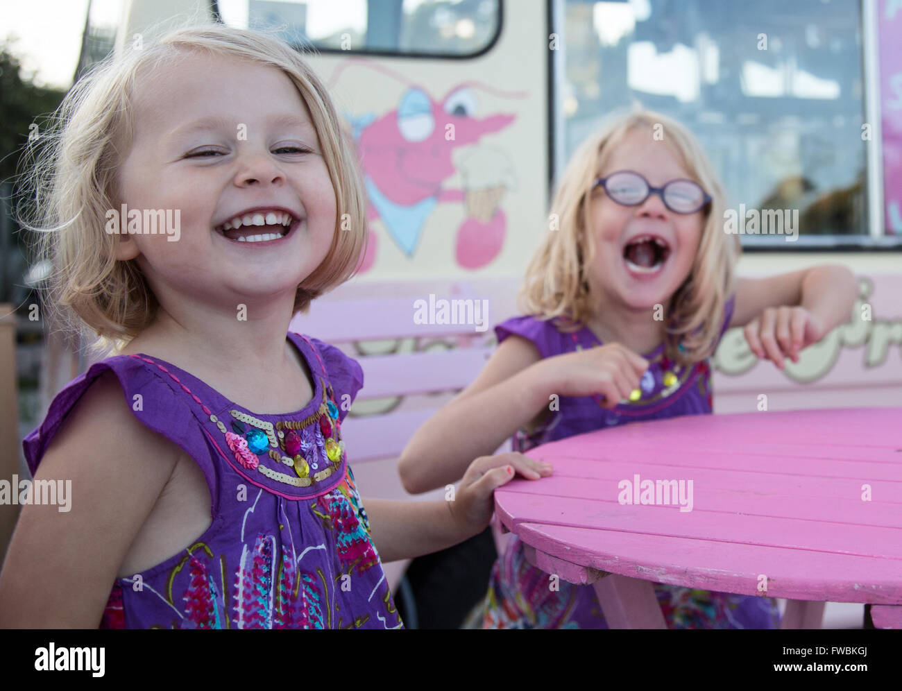 Two kids having fun and laughing in Purple Stock Photo