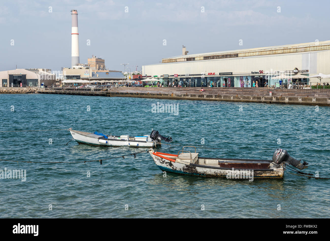 Fishing boats, shops and restaurants in Tel Aviv Port, Israel. Reading