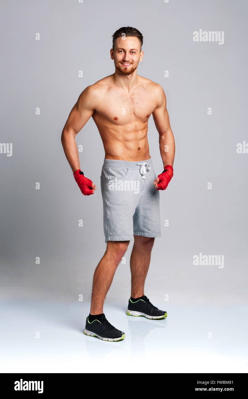 Athletic attractive man wearing boxing bandages Stock Photo