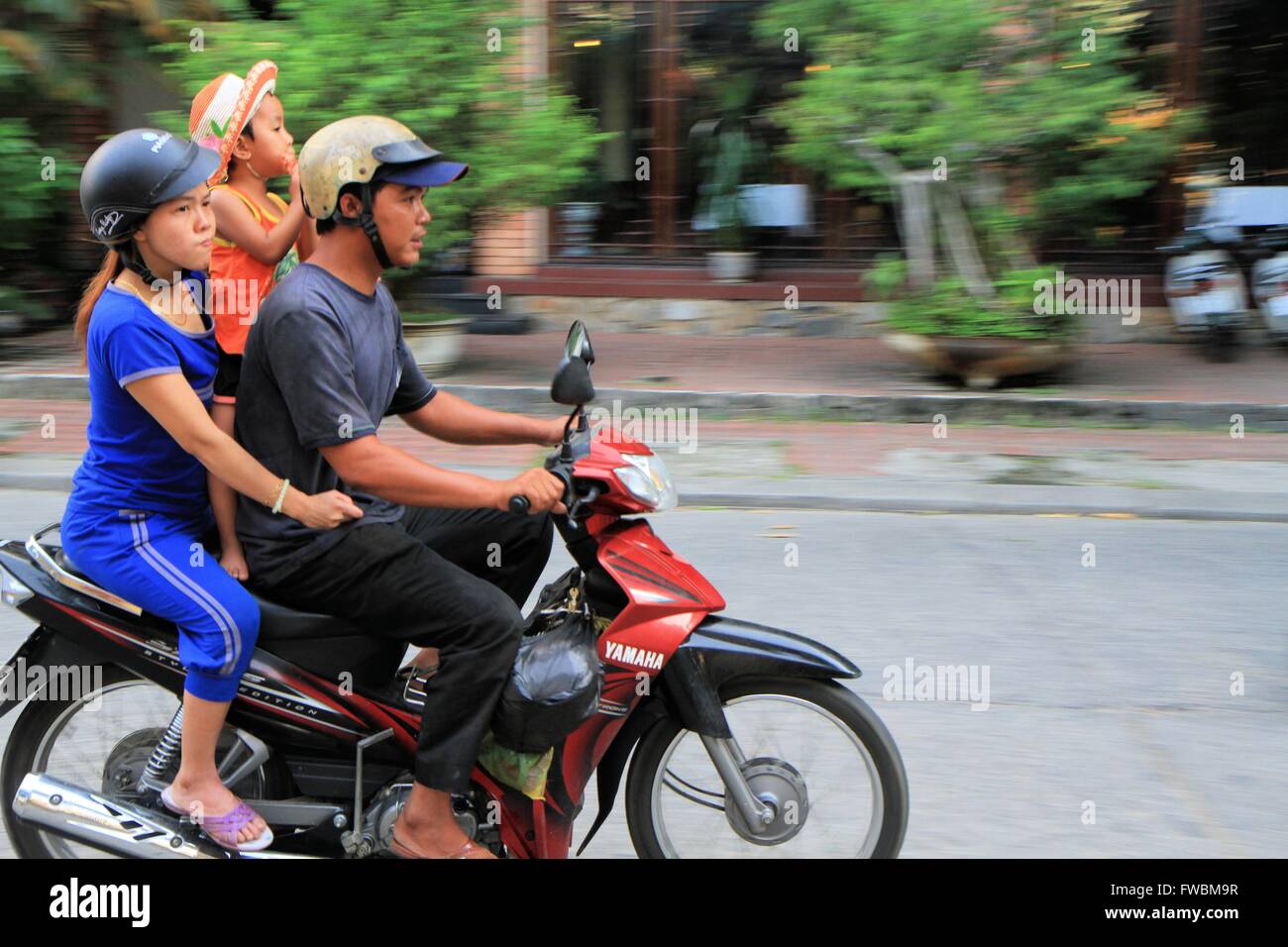 Vietnamese family riding a motorbike in Hue, Vietnam, Asia Stock Photo