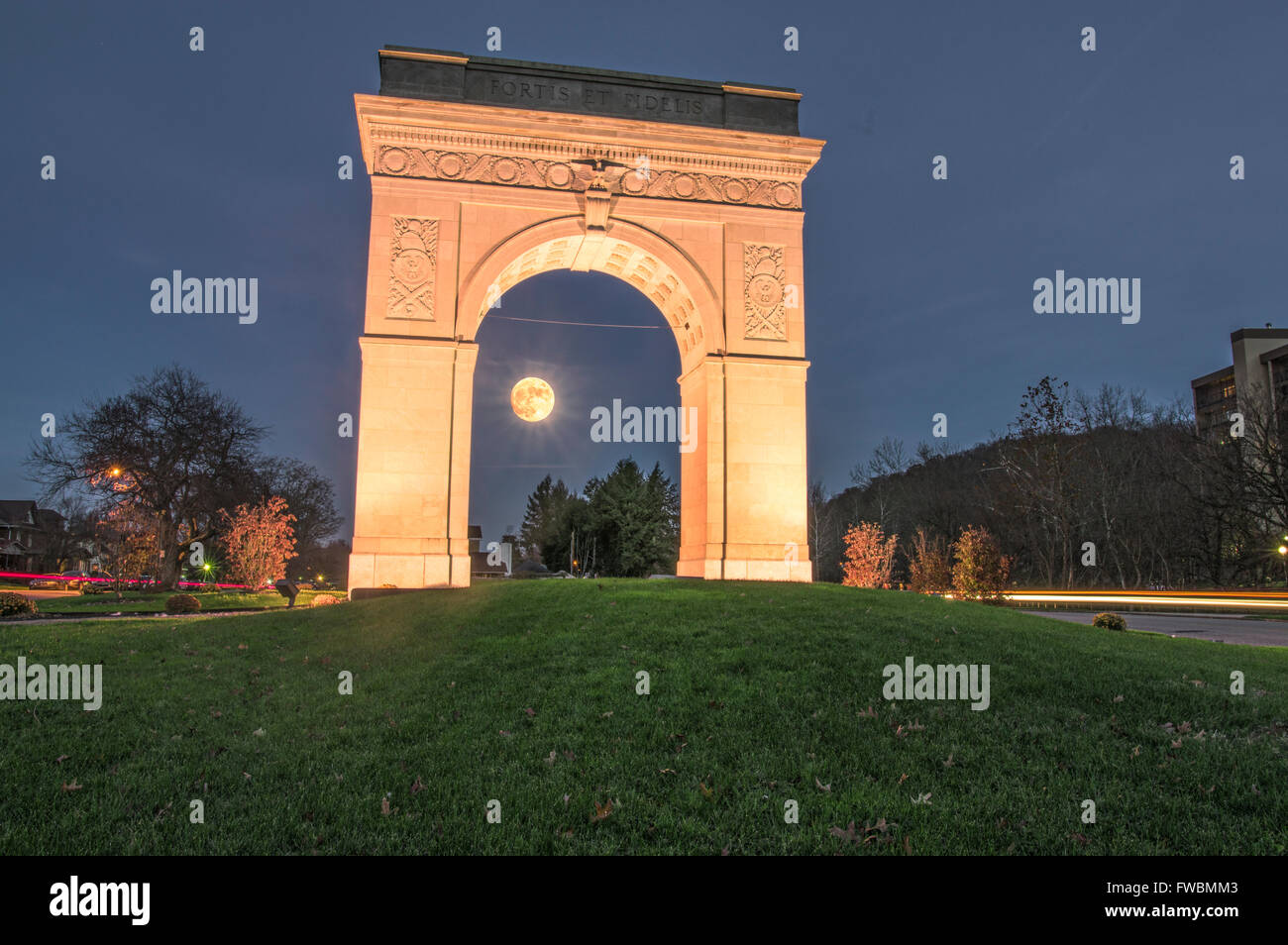 The moon rises under the WW1 Memorial Arch in Huntington, West Virginia built in the 1920's to commemorate those who served Stock Photo