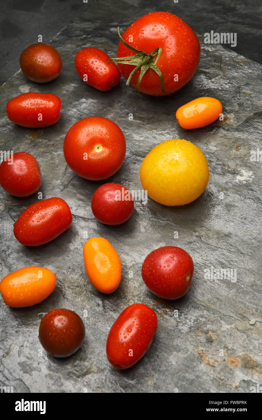 Top view of a group of medley tomatoes on a slate table. Stock Photo